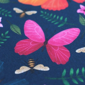 May include: A pink butterfly with dark blue wings on a dark blue background with green leaves and a yellow bee.