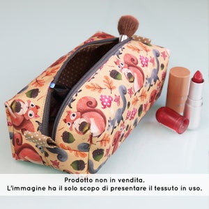 May include: A beige zippered pouch with a squirrel and acorn print. The pouch is open and has a pair of sunglasses inside.