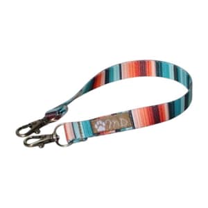 May include: A wristlet lanyard featuring a multicolored striped pattern in shades of teal, orange, black, and white. The fabric strap includes a tan rectangular patch with a white paw print and the letters MD, finished with two silver metal lobster clasps.