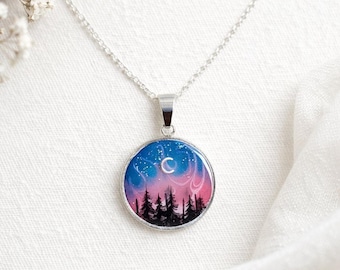 Colgante Aurora Boreal con bisel de acero inoxidable, colgante redondo de resina que brilla en la oscuridad por ambos lados.
