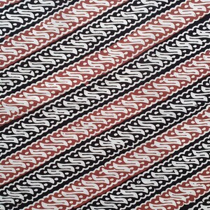 May include: Close-up of a fabric with a repeating diagonal pattern. The design features alternating stripes of black, white, and reddish-brown. The white stripes have a wavy, stylized floral motif, creating a textured appearance.