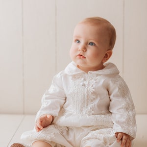 Detachable christening gown for a child with long ivory sleeves, with fine embroidered details, with high quality fabric to provide comfort to the baby