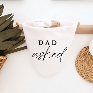 May include: White bandana with the text "DAD asked" in black lettering.