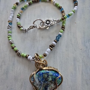 Azerite Tourquois Stone.Set in Jewellers Brass with a beaded Necklace.Hand crafted.