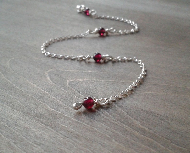 Garnet bracelet against a wooden background.