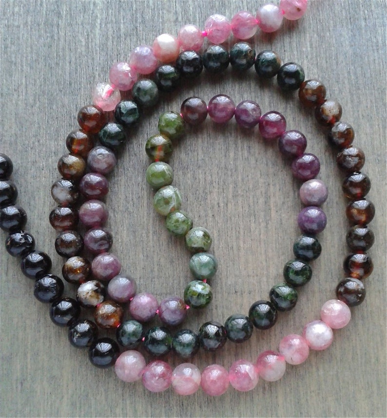 A string of tourmaline showing the various beads next to each other.