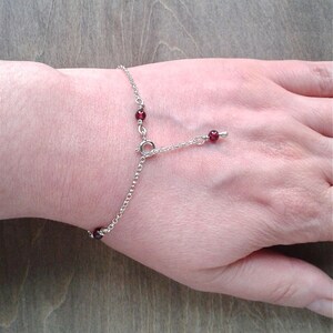 Garnet bracelet on a wrist.