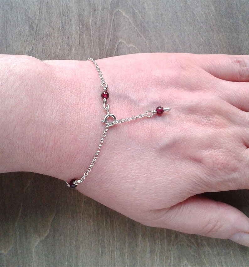 Garnet bracelet on a wrist.