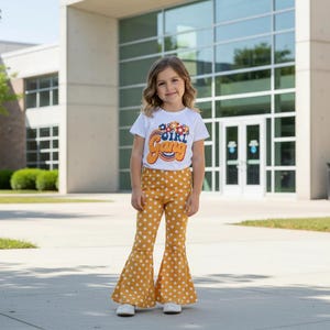 Girl wearing Gang Shirt and Yellow Polka Dot Bell Bottom Outfit – Retro Floral Vibes for Girls outfit outside her school
