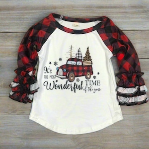 girls christmas outfits featuring red and black checkered buffalo plaid trouser pants and your choice of Merry Christmas or It's the Most Wonderful Time of the Year Long Sleeve Shirts