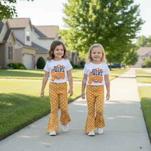 two Girls wearing Gang Shirt and Yellow Polka Dot Bell Bottom Outfit – walking down their residential street