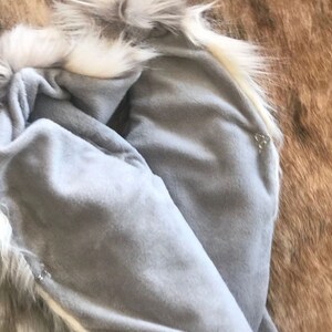 Cozy and stylish Kids' Fur Vest in a blend of grey, black, brown, and cream. Perfect for layering over any outfit, this well-made vest keeps your child warm and photo-ready. The versatile colors make it easy to mix and match with her wardrobe.