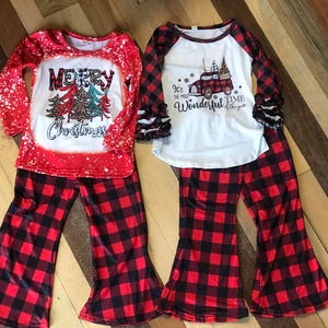 girls christmas outfits featuring red and black checkered buffalo plaid trouser pants and your choice of Merry Christmas or It's the Most Wonderful Time of the Year Long Sleeve Shirts
