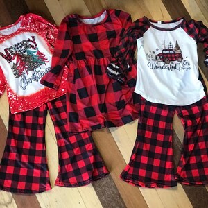 girls christmas outfits featuring red and black checkered buffalo plaid trouser pants and your choice of Merry Christmas or It's the Most Wonderful Time of the Year Long Sleeve Shirts