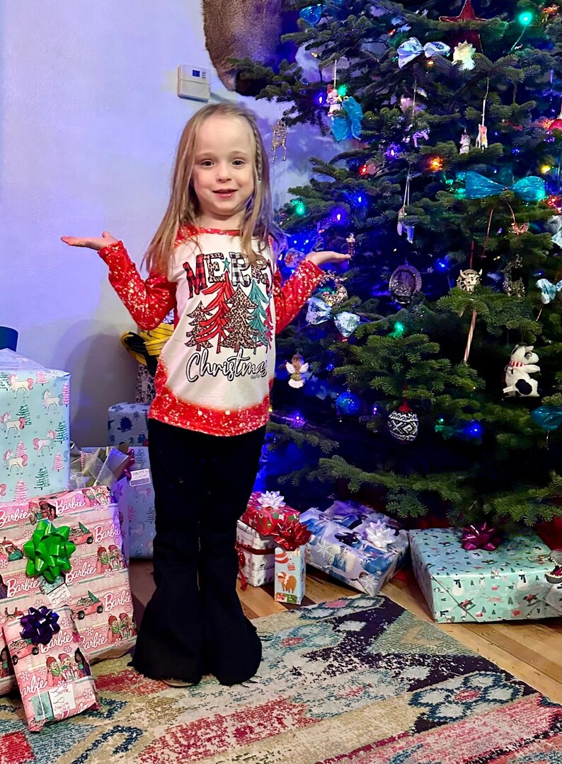 Jernie modeling MerryChristmas shirt and black jeans sold separately