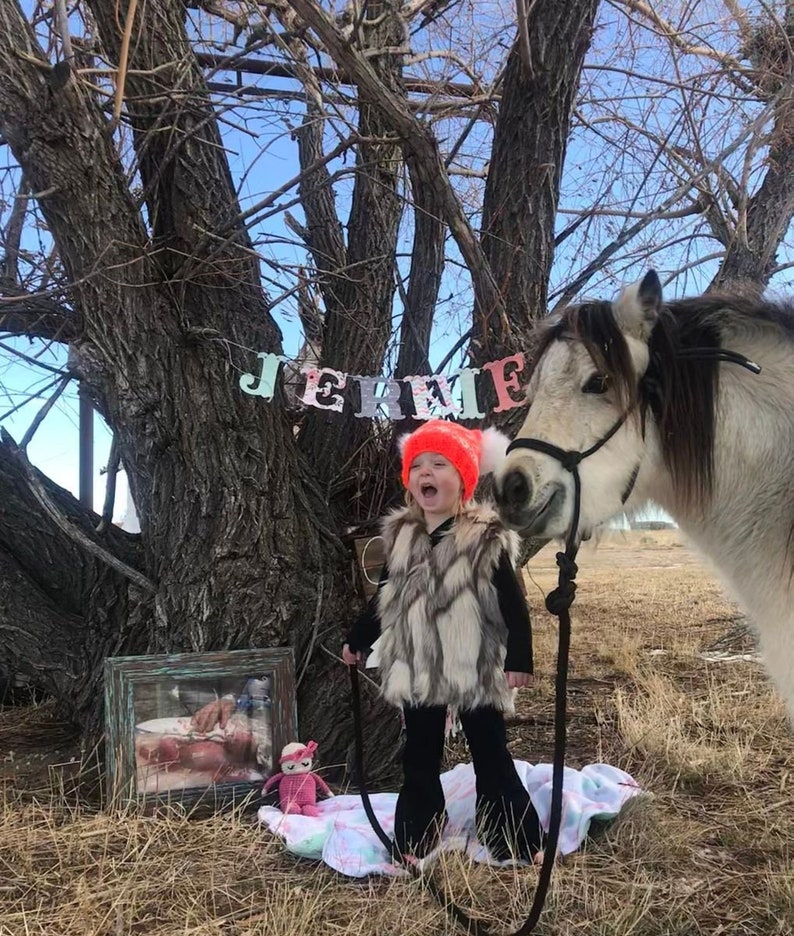 Cozy and stylish Kids' Fur Vest in a blend of grey, black, brown, and cream. Perfect for layering over any outfit, this well-made vest keeps your child warm and photo-ready. The versatile colors make it easy to mix and match with her wardrobe.