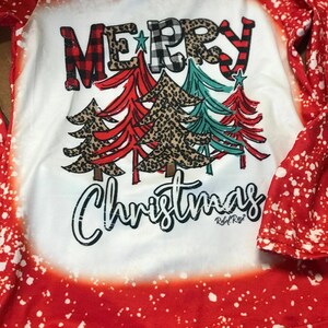 girls christmas outfits featuring red and black checkered buffalo plaid trouser pants and your choice of Merry Christmas or It's the Most Wonderful Time of the Year Long Sleeve Shirts