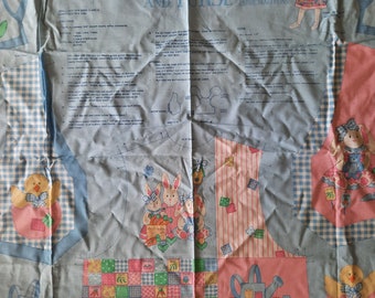 May include: A blue and pink fabric pattern for a child's vest and purse. The pattern features a bunny, a chick, and a watering can. The text on the pattern reads "Cottontail Kid's Vest and Purse".