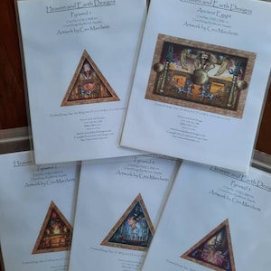 May include: Five white envelopes with printed text and images. The envelopes are labeled with the title "Heaven and Earth Designs" and feature different designs, including a pyramid, an ancient Egyptian scene, and a stylized image of a pyramid with a glowing orb.