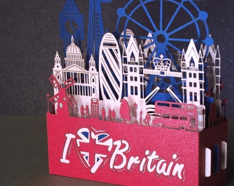 England flag. Paper pop up miniature. English Landmarks.  Red Telephone, taxi, bus, Big Ben, Tower Bridge, The Needles, St Paul’s Cathedral