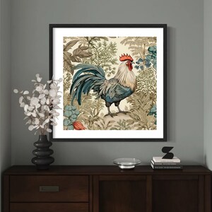 May include: A framed illustration of a rooster standing in a lush garden with green and brown foliage. The rooster has a red comb and wattle, blue and gray feathers, and a yellow beak.