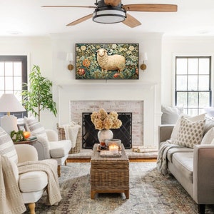 May include: A living room with a white brick fireplace, a white couch, two white armchairs, a coffee table, a ceiling fan, and a tapestry with a white sheep on it.