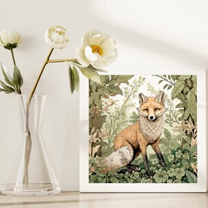 May include: A white framed print of a fox standing in a lush green forest. The fox has a reddish-orange coat and white fur on its chest and tail. The background is a detailed illustration of leaves and flowers.