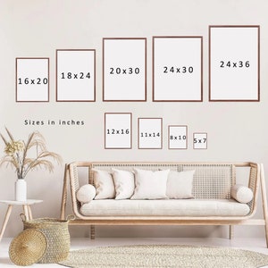 May include: A variety of picture frames in different sizes, ranging from 5x7 inches to 24x36 inches. The frames are all brown and have a simple, modern design. The frames are displayed on a white wall with a couch and a wicker basket in the foreground.