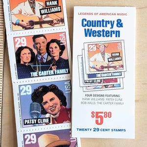 May include: A set of twenty 29-cent postage stamps featuring four country and western music legends: Hank Williams, Patsy Cline, Bob Wills, and The Carter Family. The stamps are arranged in a vertical stack with the price of $5.80 printed below.