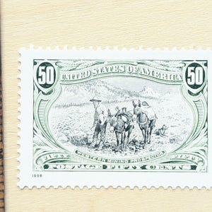 May include: A 50-cent postage stamp from 1998 featuring a detailed illustration of a Western mining prospector with two donkeys and a dog. The stamp is green and white, with the words "United States of America" and "Western Mining Prospector."