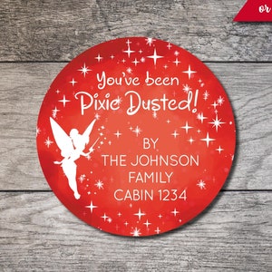 May include: Red circle with a white silhouette of Tinkerbell, stars, and the text "You've been Pixie Dusted!"  BY THE JOHNSON FAMILY CABIN 1234