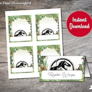 May include: Printable dinosaur-themed place cards with a green jungle background and a black silhouette of a velociraptor. The text "Raptor Wraps" is printed on the bottom of the card.