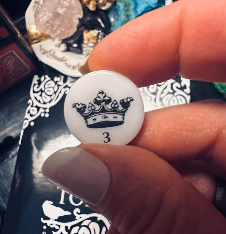 May include: White ceramic tile with a black crown and the number 3 printed on it.