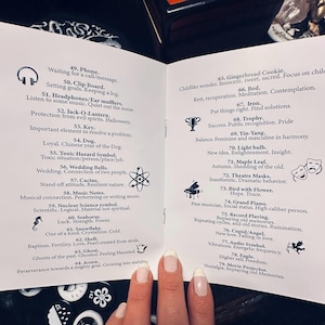 May include: A two-page spread of a small book with black and white illustrations of various objects and symbols. Each object is numbered and has a short description. The book is titled "Symbolism".