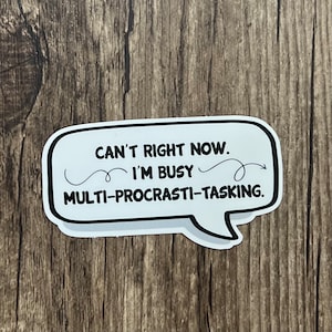 May include: White speech bubble sticker with black text that reads "Can't right now. I'm busy multi-procrastin-tasking."