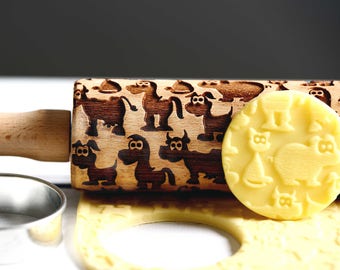 May include: A wooden rolling pin with a brown handle and a design of various animals, including cows, horses, pigs, and cats. The rolling pin is used to create decorative patterns on dough.