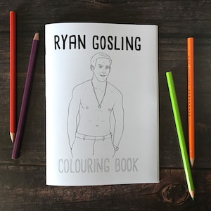 May include: A black and white coloring book featuring a line drawing of Ryan Gosling. The title of the book is "Ryan Gosling Coloring Book".