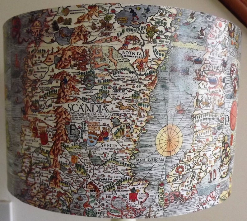 May include: A vintage-style map of Scandinavia, printed on a lampshade. The map is in shades of brown, blue, and green, with handwritten text in black. The map shows the regions of Norway, Sweden, and Finland, with the text "SCANDIA" in the center.
