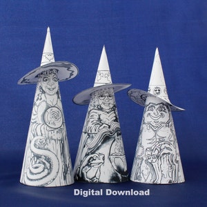 May include: Three black and white paper cone witch figures with hats and faces. The witch on the left has a snake, the middle witch has a frog and a cauldron, and the witch on the right has a cat.