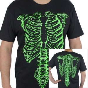 May include: Black t-shirt with a green glow-in-the-dark skeleton graphic on the front and back. The skeleton graphic includes the rib cage, spine, and pelvis.