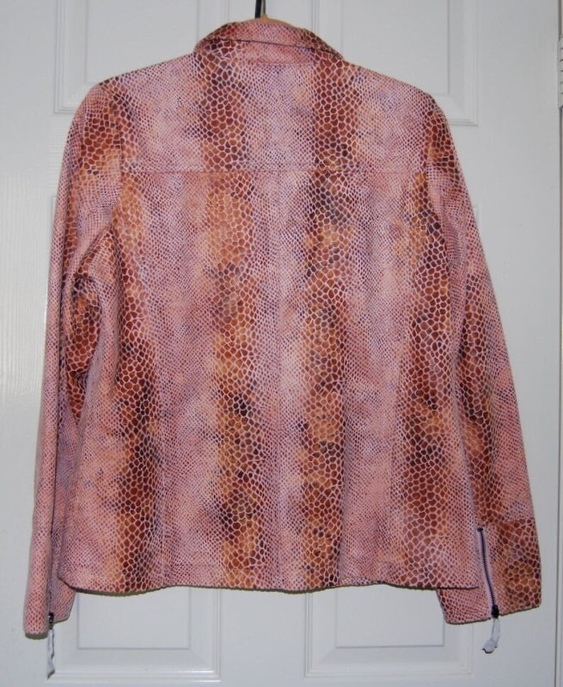 May include: A pink and brown snakeskin patterned jacket with zippered cuffs.