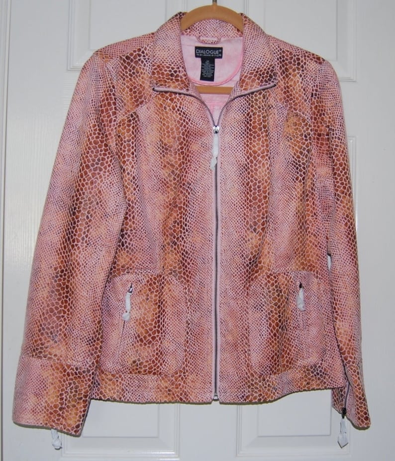 May include: A pink and brown snakeskin-patterned jacket with a zipper closure. The jacket has two pockets on the front and a label that reads "DIALOGUE" on the inside.