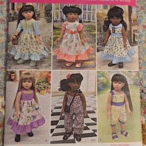 May include: A Simplicity sewing pattern envelope, number 8070, for 18-inch doll clothes. The front displays six photographs of dolls wearing various dresses, a jumpsuit, and a romper with floral, polka dot, and animal print fabrics.