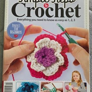 May include: A crochet book titled "Simple Steps to Crochet" with a flower project in progress. The cover features the text "Everything you need to know as easy as 1, 2, 3" and "Perfect for Beginners".
