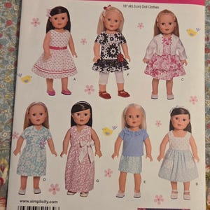 May include: Simplicity pattern 1484 for 18 inch doll clothes. The envelope features seven dolls wearing various outfits including dresses, skirts, tops, and a jacket with floral, polka dot, and solid patterns. Includes a barcode and website.