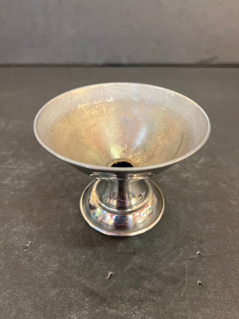 Peut inclure: Un shaker &agrave; cocktail en m&eacute;tal argent&eacute; avec une base ronde et un haut &eacute;vas&eacute;.