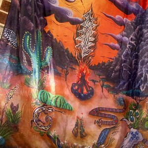 May include: A colourful, abstract painting depicting a desert landscape with a large, fiery sun in the sky. The painting features cacti, snakes, and other desert flora and fauna. The painting is done in a vibrant style with bold colours and brushstrokes.