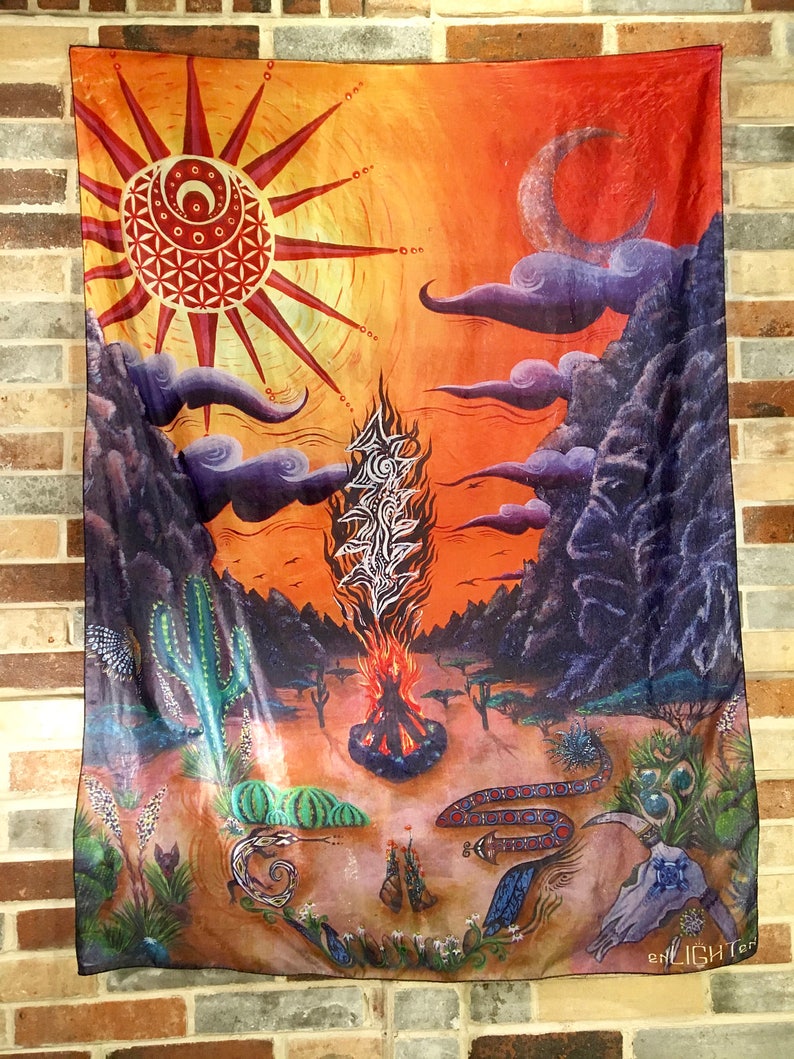 May include: A tapestry featuring a colourful, psychedelic design. The tapestry depicts a sun with a flower of life design, a crescent moon, a fire, and a snake. The tapestry is made from a soft, flowing fabric and has a fringed edge.