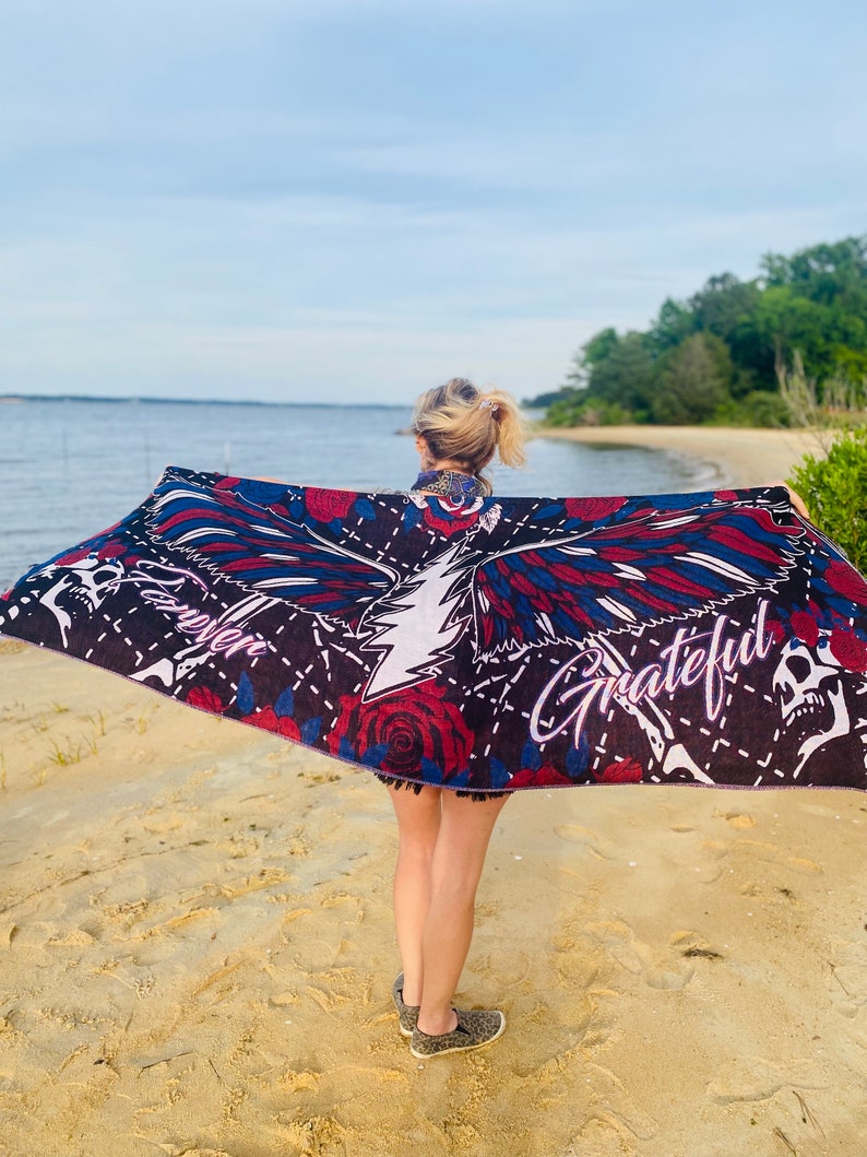 May include: A black beach towel with a colorful eagle design, roses, and the words "Forever Grateful".