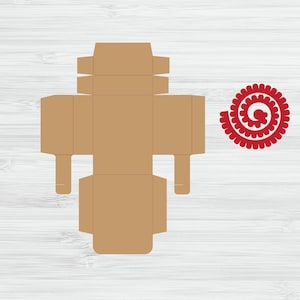 May include: A brown cardboard box template with fold lines and tabs for assembly. The box is designed to be a simple, square shape with a top flap. A red decorative swirl is shown to the right of the box.
